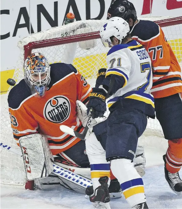  ?? ED KAISER ?? Oilers goalie Cam Talbot blocks a shot as Oscar Klefbom and the Blues’ Vladimir Sobotka battle at Rogers Place on Thursday. The Oilers lost 4-1.