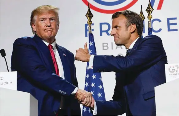  ??  ?? US President Donald Trump and his French counterpar­t Emmanuel Macron shake hands during a press conference at the G7 summit in Biarritz, France. Picture: AFP