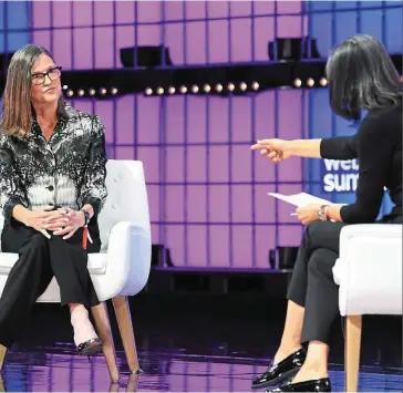  ?? — Bloomberg ?? Big buy: Ark Investment’s chief executive officer Wood (left) at a summit in Lisbon. Her investment management firm has bought more than 1.3 million shares of Coinbase in a shopping spree that is now worth about Us$56mil.