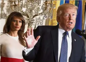  ??  ?? Tough approach: Trump, seen here at a White House event in Washington with First Lady Melania Trump, is set to unveil his plan to combat opioid abuse in New Hampshire, a state hit hard by the epidemic. — AP