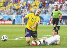  ?? Jan Kruger / Getty Images ?? Kim Min-woo of South Korea fouls Viktor Claesson of Sweden inside the box, leading to a penalty kick and the deciding goal.