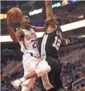  ??  ?? The Suns’ Josh Jackson (20) shoots during Wednesday’s 116-96 win over the Spurs at Talking Stick Resort Arena. Recap, 4C