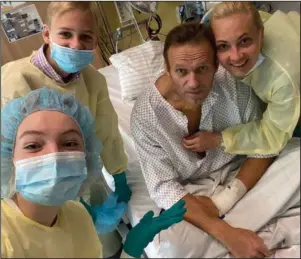  ?? The Associated Press ?? BERLIN: This handout photo published by Russian opposition leader Alexei Navalny on his instagram account, shows himself, center, and his wife Yulia, right, daughter Daria, and son Zakhar, top left, in a hospital in Berlin, Germany. Navalny posted the picture of himself in a hospital in Germany and says he’s breathing on his own.