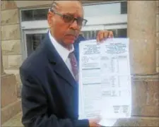  ?? ISAAC AVILUCEA - THE TRENTONIAN ?? North Ward candidate Algernon Ward Jr. holds up a sample ballot sent to a voter in the wrong ward.