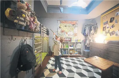  ?? STEVE RUSSELL PHOTOS TORONTO STAR ?? Wesley, 4, checks out the upper berth in his room with a custom bunk bed and wall-mounted shelving all behind a faux wall.