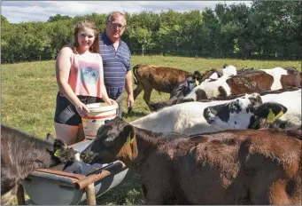  ??  ?? Jer O’Mahony with his daughter Sarah feeding calves at his farm in Ballymitty.
