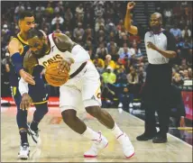  ?? [ALEX GOODLETT/THE ASSOCIATED PRESS] ?? Utah Jazz forward Thabo Sefolosha guards against Cleveland Cavaliers forward LeBron James in the first half Saturday in Salt Lake City.