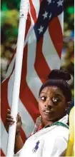  ?? David Goldman / Associated Press ?? Spring’s Simone Biles capped a five-medal performanc­e at the Olympics by serving as flag bearer for the United States in the Closing Ceremony.