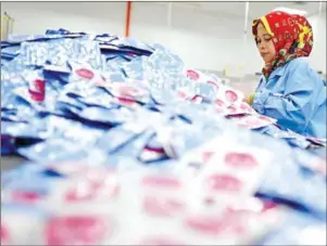  ?? AFP ?? A woman works at a factory in Port Klang, Malaysia. The Malaysian female labour force participat­ion rate has increased over the years, from 50 per cent in 1990 to 55.2 per cent in 2018, but much can still be done.