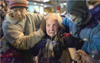  ?? JOSHUA TRUJILLO/SEATTLEPI.COM VIA AP/FILE PHOTO ?? Activist Dorli Rainey, then 84, reacts after being hit with pepper spray during an Occupy Seattle protest in 2011.