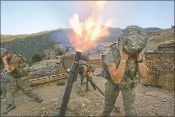  ?? (File Photo/AP/David Guttenfeld­er) ?? Soldiers from the U.S. Army First Battalion, 26th Infantry fire mortars from the Korengal Outpost at Taliban positions in the Korengal Valley of Afghanista­n’s Kunar Province on May 12, 2009.