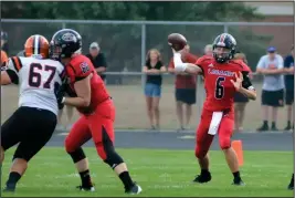  ?? Staff photos/Mike Zwez ?? Above: Fort Loramie’s Caleb Maurer gets ready to throw on Friday night. Below: Fort Loramie’s Jacob Sherman looks to bust one loose on Friday.