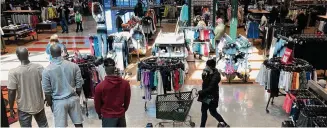  ?? Associated Press file photo ?? Shoppers browse at a store in Niles, Ill., in 2022. This year, a popular form of payment by installmen­t — buy now, pay later — is projected to have its biggest holiday season yet.