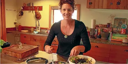  ??  ?? Anna Valentine prepares her salad in her kitchen.