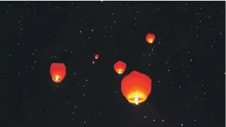 ?? Reuters; EPA; Pixabay ?? Lanterns are an integral part of Chinese New Year celebratio­ns, such as, top, a giant dog lantern in Shanghai; left, red lanterns hung from trees in Beijing; and a traditiona­l ceremony in China. Tomorrow marks the start of the New Year, which is the...