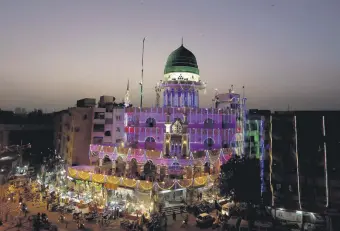  ??  ?? A mosque is decorated with lights for the Mawlid an-Nabi holiday celebratin­g the birthday of the Prophet Muhammad, in Karachi, Pakistan, Oct. 25, 2020.