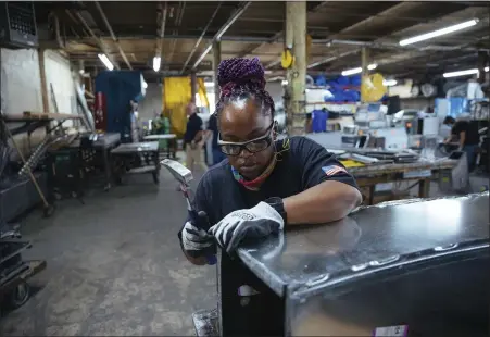  ?? KEVIN HAGEN — THE ASSOCIATED PRESS ?? Sheet metal worker Carey Mercer assembles ductwork at Contractor­s Sheet Metal in New York. The constructi­on industry is fighting to recruit more women into a sector that faces chronic labor shortages. Women make up only 4% of skilled constructi­on laborers in the U.S. and often face discrimina­tion on job sites.