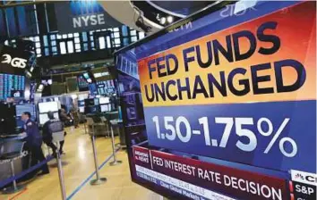  ?? AP ?? A television at the New York Stock Exchange shows the rate decision of the Federal Reserve on Wednesday. Analysts expect three more rate hikes this year as the Fed left the rate target unchanged.