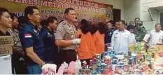  ??  ?? POLIS Jakarta Barat mempamerka­n produk makanan yang dirampas dan suspek yang ditangkap dalam satu sidang media di sebuah gudang di Tambora, kelmarin. - Warta Kota