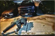  ??  ?? A DEA agent checks under a car at a residentia­l house during an arrest of a suspected drug trafficker Wednesday in Diamond Bar, Calif.