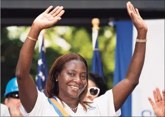  ?? John Minchillo / Associated Press ?? Grand Marshal Sandra Lindsay waves to spectators at the end of a parade Wednesday honoring essential workers for their efforts in getting New York City through the COVID-19 pandemic.