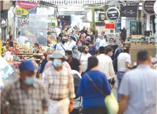  ?? (Marc Israel Sellem/The Jerusalem Post) ?? SHOPPERS STROLL through Mahaneh Yehuda market yesterday.