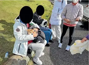  ?? DOC ?? People were spotted with cats in their packs on Taranaki Maunga by Department of Conservati­on staff. DOC has chosen to conceal their faces in these photos.