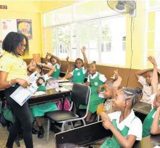  ?? CONTRIBUTE­D ?? Nadeen Matthews Blair, NCB Foundation CEO, engages grade three students from Pembroke Hall Primary School, as she reads Abigail’s Glorious Hair by Jamaican author Diane Browne, on Read Across Jamaica Day 2023.