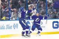  ??  ?? Lightning centre Yanni Gourde, right, celebrates his secondperi­od goal with defenceman Mikhail Sergachev at Amalie Arena.