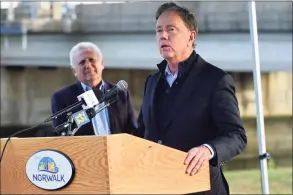  ?? Erik Trautmann / Hearst Connecticu­t Media ?? Gov. Ned Lamont announces state aid for flood mitigation efforts during a news conference Friday at Municipal Parking lot on the Norwalk River in Norwalk.