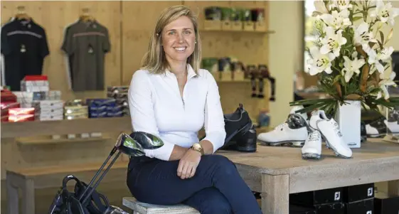 ??  ?? SETTLING IN: New Toowoomba Golf Club profession­al Leah Hart settling in her new pro shop surrounds yesterday at Middle Ridge golf course.