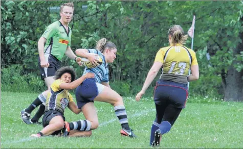  ?? CAROLE MORRIS-UNDERHILL ?? Acadia University’s Monique Coffey put on a spectacula­r display June 28, tackling players, scoring tries and assisting in big plays for the Machine. Also pictured running in support is Carla de Toit.