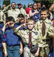  ?? JAKE MAY / AP ?? Boy Scouts and Cub Scouts salute during a Memorial Day ceremony in Linden, Mich. On Wednesday, the Boy Scouts of America board of directors unanimousl­y voted to welcome girls into its Cub Scout program and to introduce an Eagle Scout program for girls.