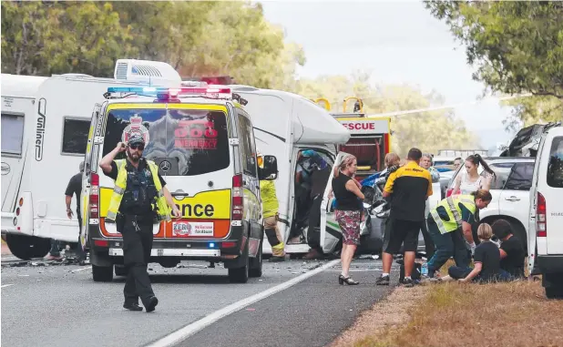  ??  ?? TRAGIC EVENT: Emergency services at the scene of the crash on the Kennedy Highway south of Mareeba. Picture: STEWART McLEAN