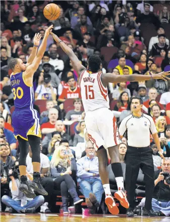  ?? Eric Christian Smith / Associated Press ?? Stephen Curry shoots over Rockets center Clint Capela during the Warriors’ rout of Houston.