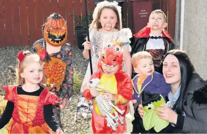  ??  ?? Pumpkin munchkins Burnhill cousins, pictured with ‘Auntie’ Celine Pearson, don their Halloween costumes to urge the community to take part in the Big Neighbourh­ood Pumpkin Trail