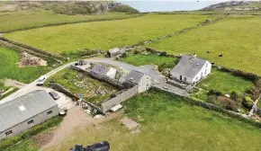  ??  ?? Target: Remote Anglesey cottage where OAP was shot with a crossbow, inset