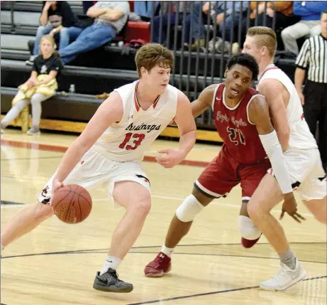  ?? RICK PECK SPECIAL TO MCDONALD COUNTY PRESS ?? Peyton Barton (right) sets a screen on Joplin’s Evan Guillory to allow Cooper Reece to drive to the basket during the Eagles’ 56-47 win on Monday night at McDonald County High School.