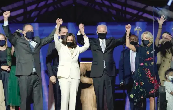  ?? ANDREW HARNIK/ AP ?? From left: Doug Emhoff, husband of Vice President- elect Kamala Harris, Harris, President- elect Joe Biden and his wife Jill Biden celebrate their victory Saturday.