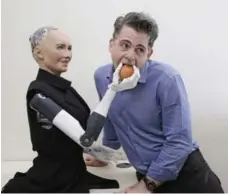  ?? KIN CHEUNG/THE ASSOCIATED PRESS ?? David Hanson, the founder of Hanson Robotics, shows his company’s flagship robot Sophia, a lifelike robot powered by artificial intelligen­ce.