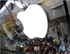  ?? AP PHOTO/MATTHIAS SCHRADER ?? In this 2015 file photo, people wait in front of the Apple store in Munich, Germany. IDFA (Apple’s Identifier for Advertiser­s) allows Apple and all apps on the phone to track a user and combine informatio­n about online and mobile behaviour.