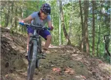  ?? STAFF PHOTO BY MARK PACE ?? Kathryn Volzer with Lula Lake Land Trust rides the new Moonshine Trails in Lookout Mountain, Ga.