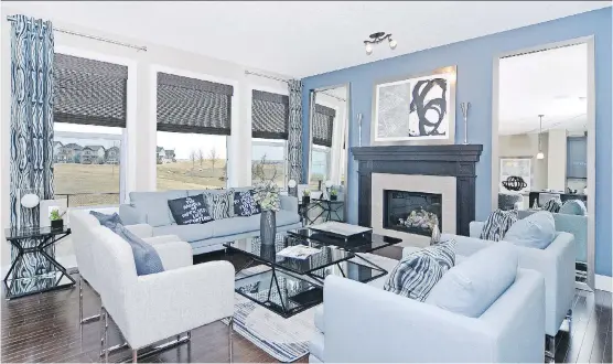  ?? PHOTOS: STERLING HOMES ?? The great room in the Berkshire 2 by Sterling Homes in Nolan Hill has a rear window wall and a fireplace with a ceramic tile face.