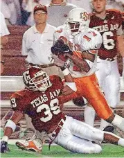  ?? ARCHIVES] ?? R.W. McQuarters, right, catches a pass for Oklahoma State during a 1997 game against Texas A&M. McQuarters played both offense and defense for the Cowboys.