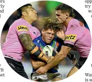  ?? ?? Reece Walsh is sandwiched in the tackle of two Penrith players.