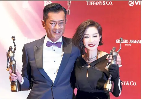  ?? — Reuters ?? Koo (left) and Mo are all smiles after winning the Best Actor and Best Actress awards respective­ly at the Hong Kong Film Awards.