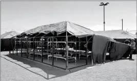  ?? ASSOCIATED PRESS ?? MARICOPA COUNTY SHERIFF PERSONNEL BREAK DOWN A TENT in a controvers­ial outdoor jail complex Wednesday in Phoenix. One of the five jail yards within the “Tent City” has already been dismantled, and workers on Wednesday were in the process of tearing...