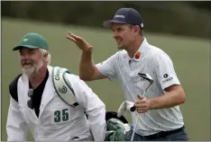  ?? CURTIS COMPTON — ATLANTA
JOURNALCON­STITUTION ?? Justin Rose and his caddie David Clark react to his second shot on the 18th hole during the first round of the Masters at Augusta National
Golf Club on Thursday in Augusta, Ga.