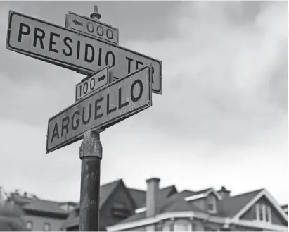  ?? AP PHOTOS ?? Street signs mark the intersecti­on of Presidio Terrace and Arguello at the entrance to a private neighborho­od in San Francisco where a real-estate investor was able to purchase a street and sidewalks at a city auction stemming from an unpaid tax bill.