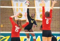  ?? GARY MIDDENDORF / DAILY SOUTHTOWN ?? Marian Catholic’s Lauren Hatch (13) goes up for the kill against Mother McAuley during a 2018 match.